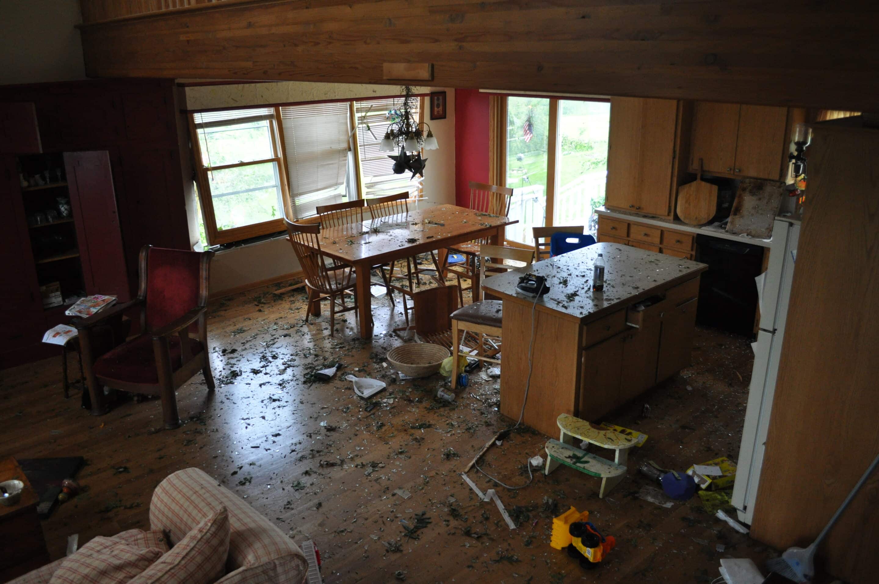 Water and debris across a damaged residential interior