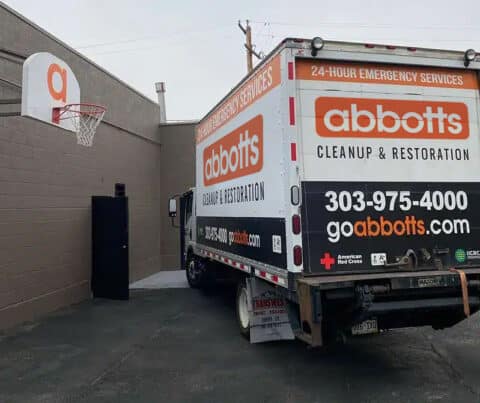 Abbott's Cleanup & Restoration 24-hour emergency services box truck parked outside a building