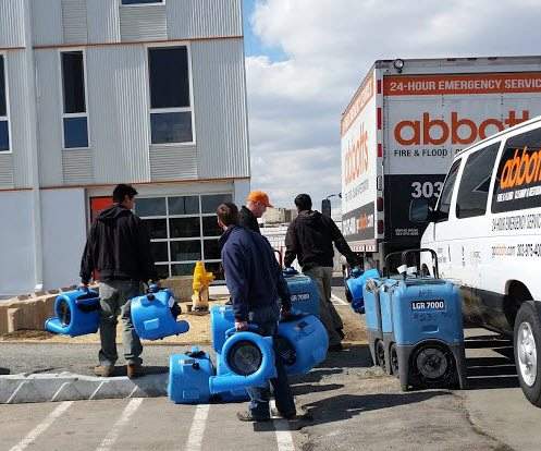Abbotts crew with drying equipment beside a service truck
