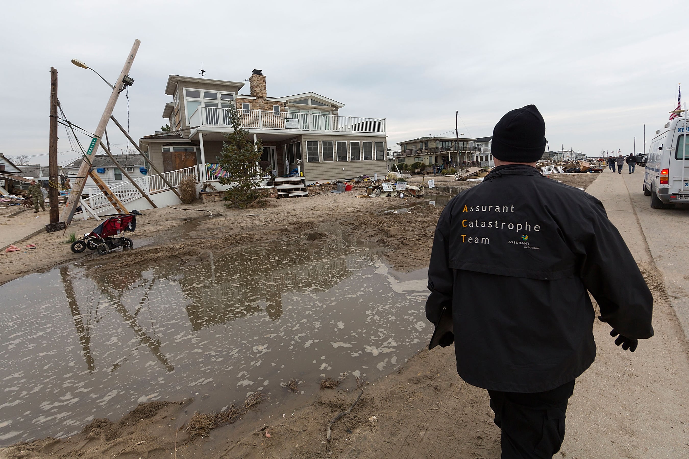 Person surveying damaged homes and storm debris