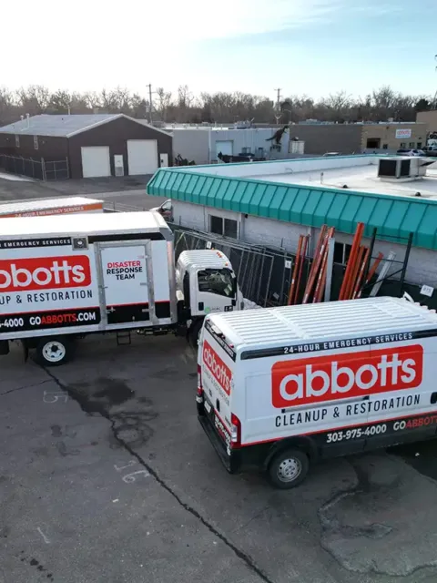 water-9 Abbott's restoration trucks parked outside a building